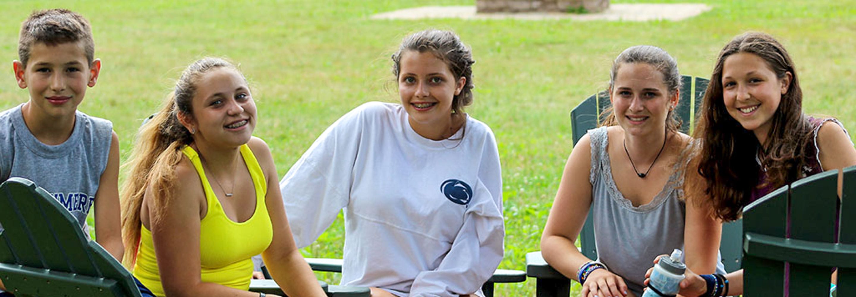 campers in chairs smiling