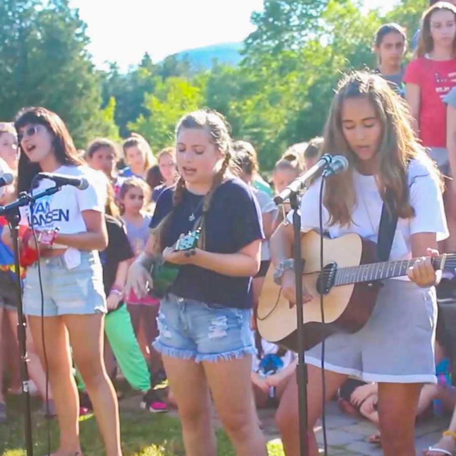 campers and staff playing guitars