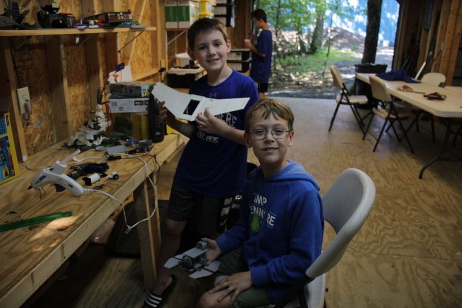 Two boys working on mini rockets.