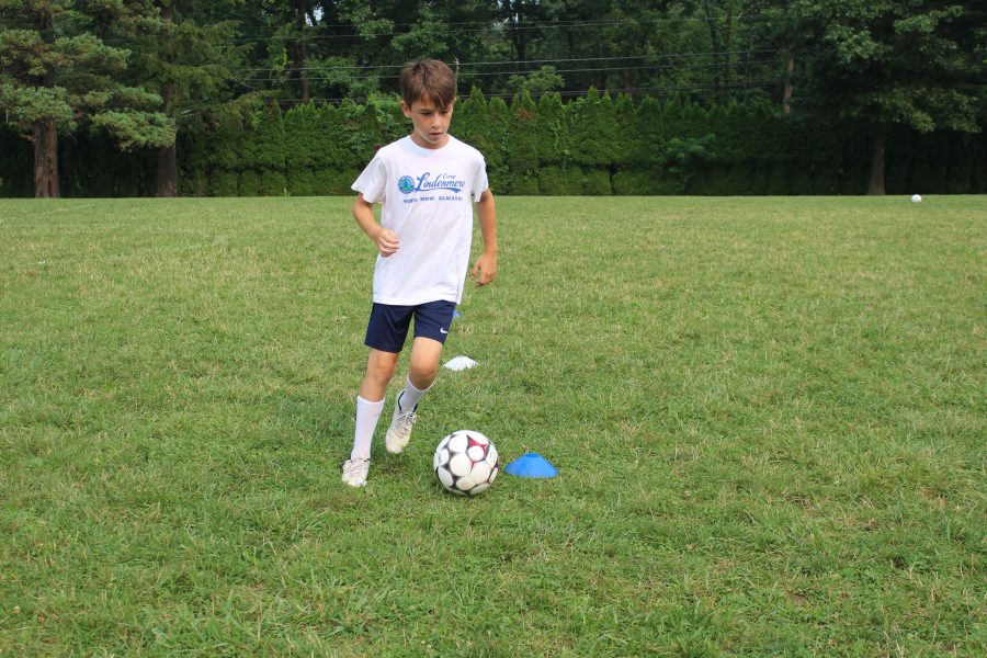 A boy with a soccer ball.